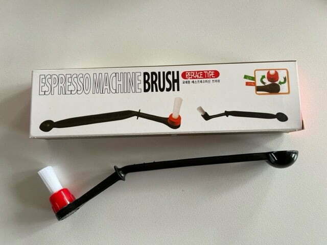 Shower plate cleaning brush and measuring spoon